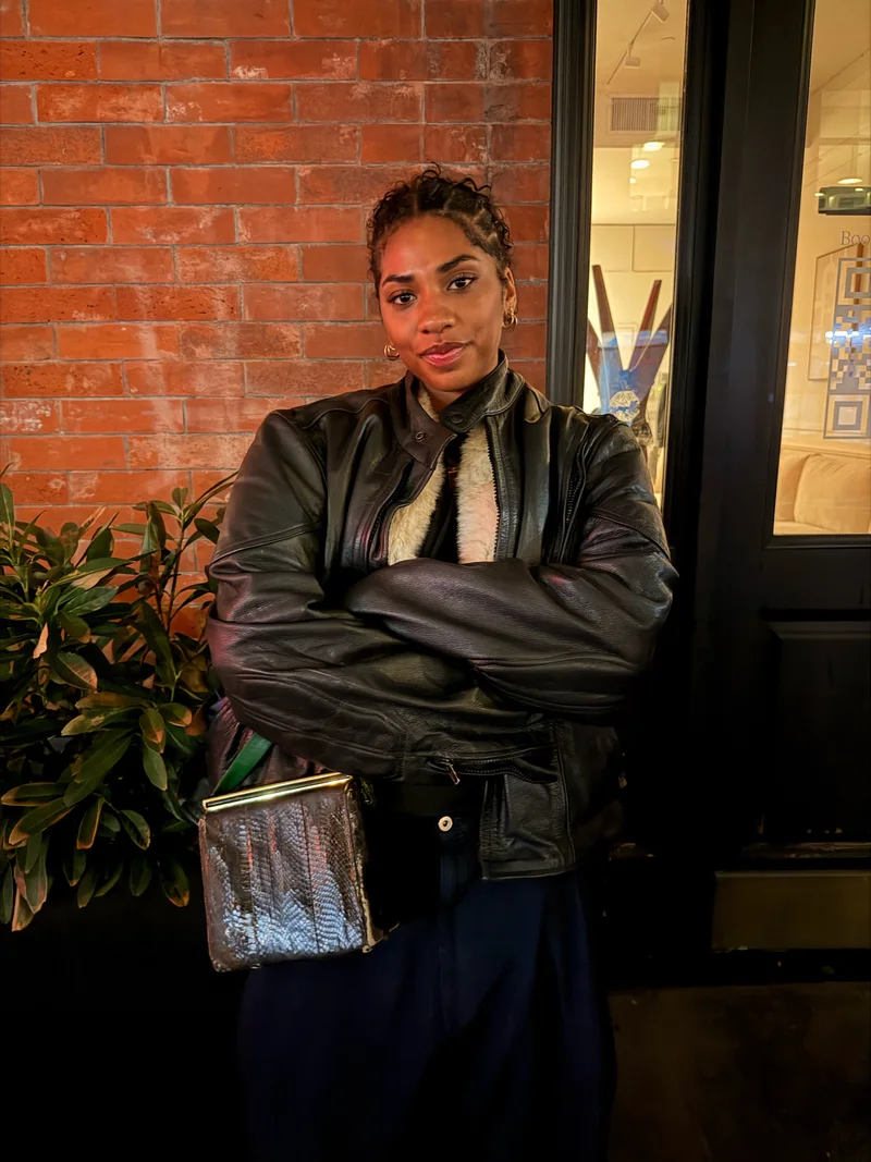 Contessa Martin, founder and executive director of Families Beyond Bars, standing with her arms crossed in front of a brick wall